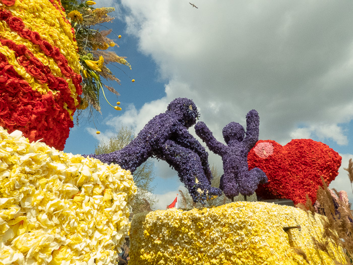 Endless row of floats on flower parade through the Dutch bulb fields love jumping figures Keith Herring