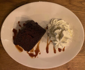 Cholate cake with whipped cream and sticky toffee sauce